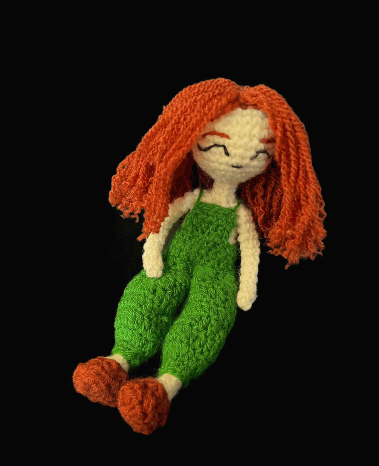 Crochet doll with orange hair and green clothes